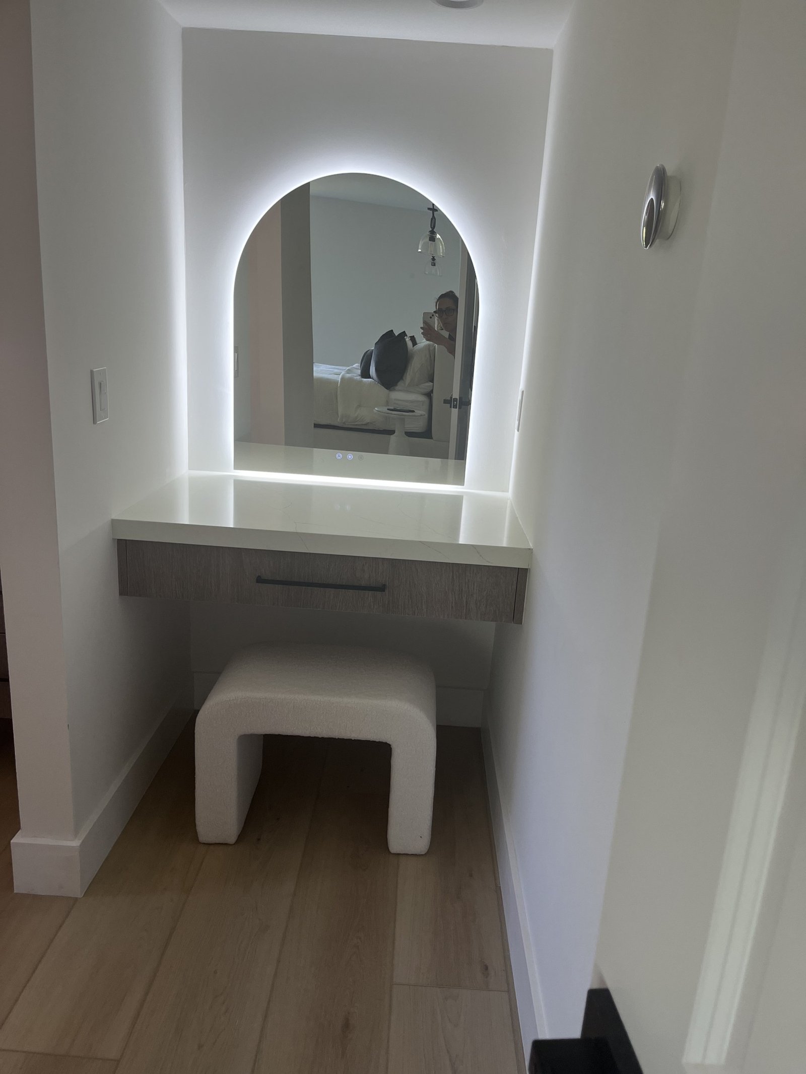 Dressing vanity with illuminated arched mirror